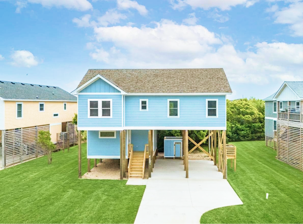 Finished light-blue house raised on stilts